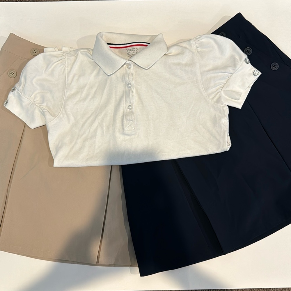 Two large Cat & Jack school skorts. A large white French Toast polo